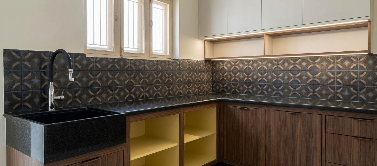 Clean L-shaped modular kitchen with black granite counter, patterned backsplash and walnut cabinets
